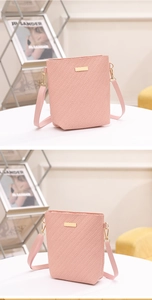 Detail of pink woven bucket bag featuring gold metal hardware and a textured finish