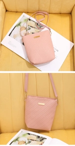 Detail of pink woven texture crossbody bag featuring gold metal plate and adjustable strap