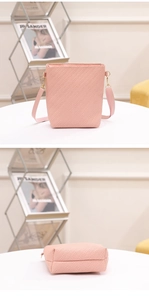 Detail showing pink woven texture and gold-tone metal hardware on the bucket bag