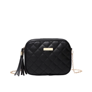 Quilted black crossbody bag with gold chain strap and tassel charm on white background