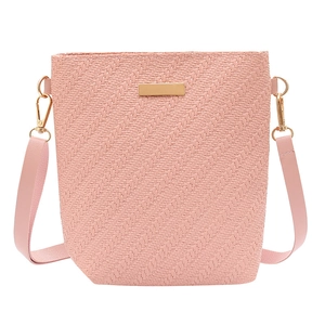 Chic pink bucket bag with embossed woven texture and elegant gold metallic hardware