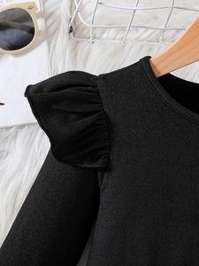 Detailed view of black cotton dress featuring sweet ruffled sleeve design for girls