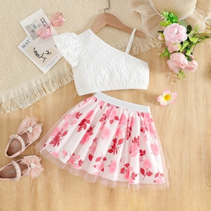 Detail of girls floral mesh skirt and one-shoulder white relief flower top set