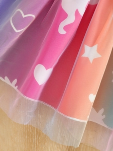 Detailed macro view of colorful rainbow tulle layers with heart and star prints