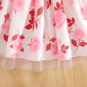 Detailed close-up of pink rose floral patterns and layered mesh hem on girls' tulle skirt