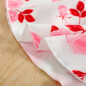 Close-up of floral print mesh skirt featuring pink roses and fine hemline stitching