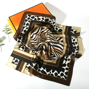 Macro view of animal print silk scarf featuring zebra stripes and soft fabric texture