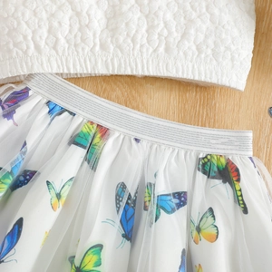 Detail of baby girl's mesh skirt featuring colorful butterfly prints and textured top
