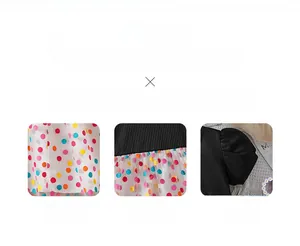 Detailed view of white tulle fabric with colorful polka dots and elastic waistband
