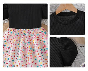 Close-up of girls' black ribbed bodice and colorful polka dot tulle mesh skirt detail