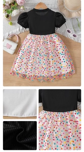 Detailed close-up of girls' black ribbed bodice and white tulle skirt with colorful polka dots