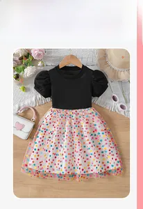 Flat lay of girl's summer dress with black ribbed top and rainbow polka dot tutu skirt