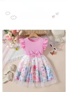 Detail of pink girls' dress showing winged sleeves, waist bow and floral mesh skirt