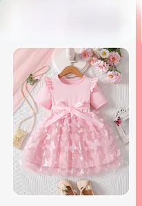 Detail of girls' pink princess dress with 3D floral butterflies and layered mesh skirt