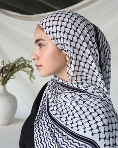 Detail of classic black and white checkered keffiyeh scarf with fringed edges