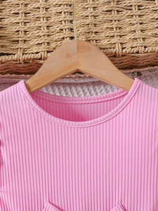Pink knit ruffle sleeve toddler dress with mesh skirt and bow detail on wood hanger