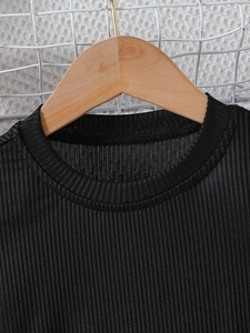Girls black knit tank dress with ribbed texture and round neck on wooden hanger