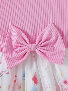 Pink striped knit girls dress featuring a large waist bow and white mesh floral skirt