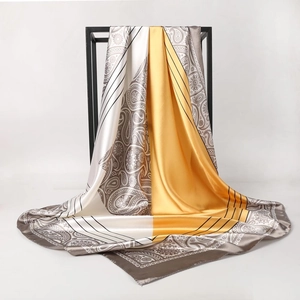 90cm vintage paisley pattern satin silk scarf in gold and gray on a minimalist stand