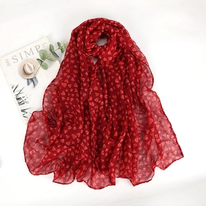 Long red heart-print chiffon scarf for women shown on a clean white background