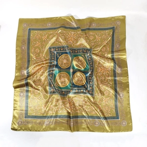 Detailed top view of 90cm square satin scarf featuring golden Baroque pattern on white background