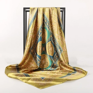 Close-up of baroque pattern on vintage silk satin scarf with black and gold details