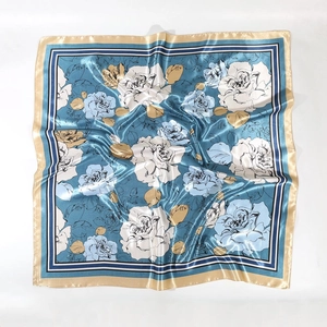 Satin floral square scarf with elegant rose patterns and gold borders on a blue base