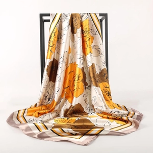 Detail of satin floral scarf showing soft silk texture and artistic rose pattern print