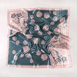 Detail view of square silk scarf with vintage green rose print and satin finish