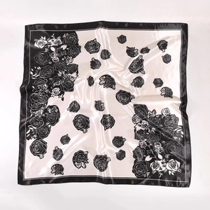 Detail of black and white rose floral print on glossy satin square scarf fabric