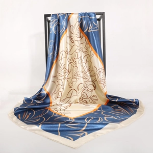 90cm floral satin silk scarf in navy and beige with orange border hanging on frame