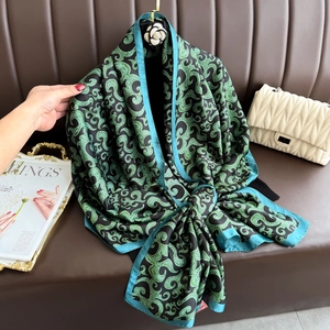 Luxurious green and black silk scarf with vintage ornate patterns and blue border