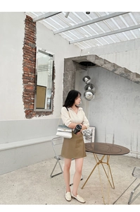 Chic gradient diamond quilted shoulder bag paired with a beige knit top and leather skirt