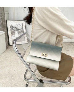 Detail of gradient quilted shoulder bag with gold twist lock and metal chain strap