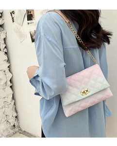 Close-up of pink and purple gradient quilted crossbody bag with gold chain strap and lock