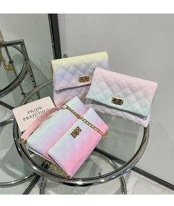 Close-up of diamond quilted crossbody bags with gradient macaron colors and gold twist locks