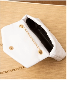 Détail de l'intérieur d'un sac bandoulière blanc matelassé avec chaîne dorée chic