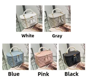 Détails de sacs seaux matelassés en blanc, gris, bleu, rose et noir avec poignée en perles