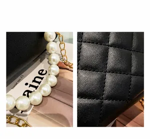 Close-up of black quilted PU leather texture and elegant large pearl handle of the bucket bag