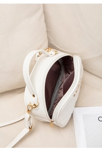 Overhead interior view showing brown silk lining and spacious main pocket of white quilted bag