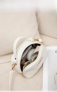 Detail view of white quilted handbag interior showing spacious multi-compartment storage