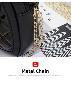 Detail of multi-layer plated gold metal chain on black quilted square crossbody bag