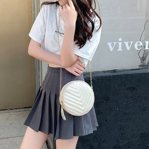Chic beige round quilted chain crossbody bag with tassel detail for women