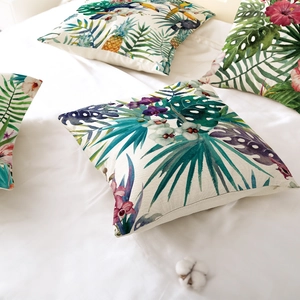 Tropical leaf and toucan print pillow cover on white bedding for home decor