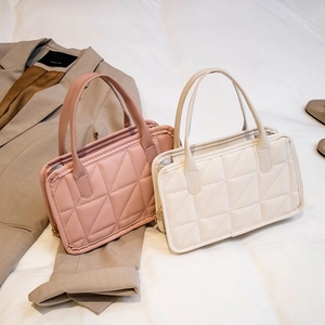 Pink and beige quilted leather handbags with chain straps in a stylish lifestyle setting