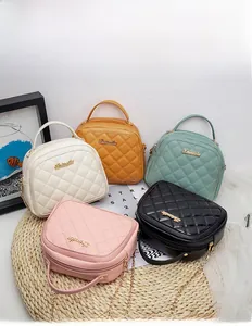 Quilted crossbody bags in assorted colors with gold chain straps on decorative mat
