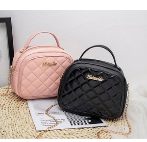 Detail of pink and black quilted leather mini bags with gold chain straps and metal logo