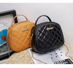 Detail of quilted leather crossbody bags with golden chain straps and metallic logo