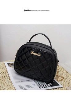 Detail of black quilted PU leather crossbody bag with gold chain and Hutweilu logo