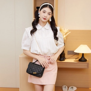 Quilted black chain bag with white Peter Pan collar shirt and pink skirt outfit